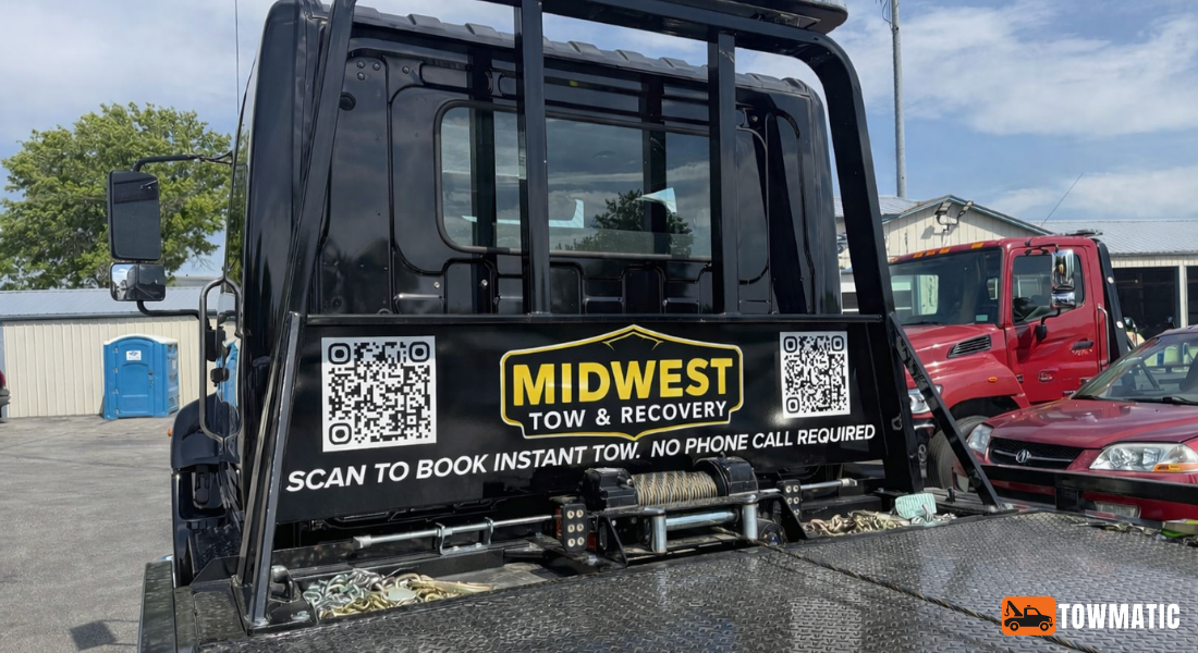 Tow truck with a Midwest Tow & Recovery decal and QR codes reading Scan to book instant tow — no phone call required